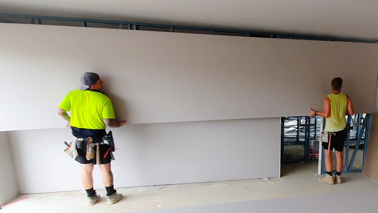 Pro Drywall Crew Fixing Long Walls with 1 Length of Plasterboard