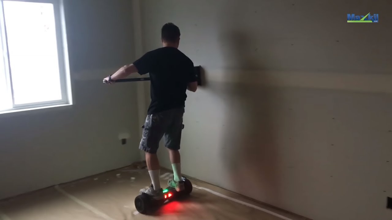 Drywall Construction Worker Uses Flat Box while Riding Hoverboard