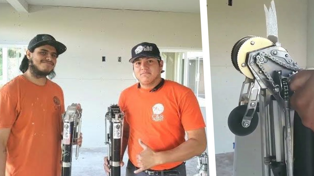 Drywall Construction Workers Tape in with an Automatic Taper Bazooka